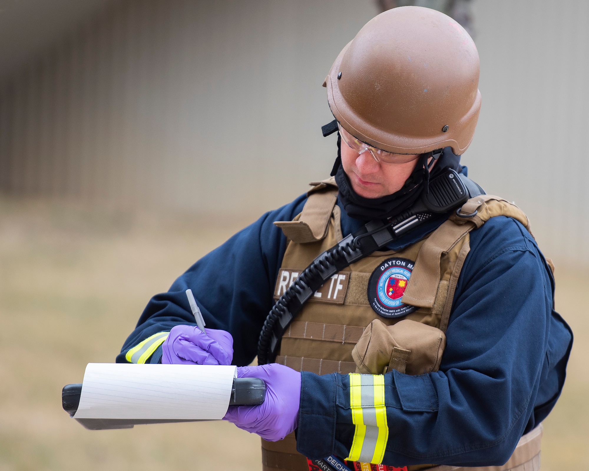 A Fire Department paramedic with the 788th Civil Engineer Squadron keeps track of the “dead” and “wounded” during an active-shooter exercise Feb. 23, 2022, at Wright-Patterson Air Force Base, Ohio. The exercise gave first responders, including police, fire and medical personnel, the opportunity to practice coordinating emergency actions and procedures. (U.S. Air Force photo by R.J. Oriez)