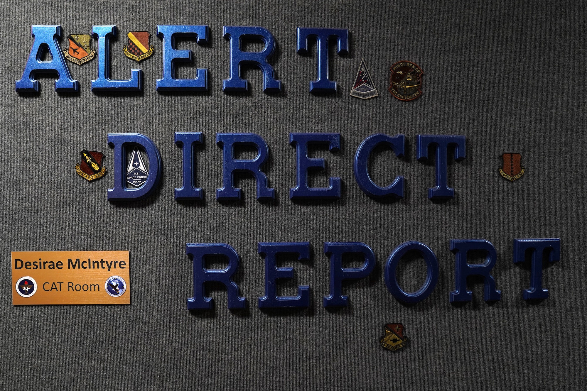 The words "Alert Direct Report" are displayed at the entrance of a classroom dedicated to Master Sgt. Desiree McIntyre, 403rd Wing command and control technician, located in Cody Hall at Keesler Air Force Base, Mississippi, Feb. 25, 2021. McIntyre dedicated 30 years to the command post career field, providing instrumental training techniques and developing the training curriculum. (U.S. Air Force photo by Senior Airman Seth Haddix)