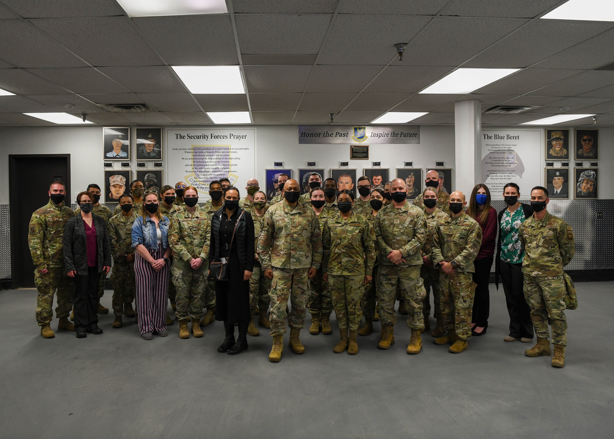 Security forces Airmen and Gen. Anthony Cotton, Air Force Global Strike Command commander and Chief Master Sergeant Melvina Smith AFGSC command chief, stand for a photo at Minot Air Force Base, North Dakota, Feb 24, 2022 While touring, Gen. Cotton learned about the many programs Airmen and spouses at Minot AFB have organized to foster a relationship between Airmen, and how the command could continue to support them. (U.S. Air Force photo by Airman 1st Class Evan Lichtenhan)