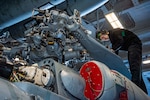 Aviation Machinist's Mate Airman James Nickley, from Orlando, Florida, inspects corrosion on the main rotor head of the MH-60S Sea Hawk helicopter in the hangar bay of the Nimitz-class aircraft carrier USS Harry S. Truman (CVN 75), Feb. 24, 2022. The Harry S. Truman Carrier Strike Group is on a scheduled deployment in the U.S. 6th Fleet area of operations in support of U.S., allied and partner interests in Europe and Africa.