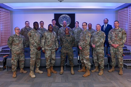 Military members gather to discuss partnership and collaboration.