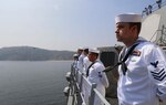 Sailors man the rails as the Arleigh Burke-class guided-missile destroyer USS Fitzgerald (DDG 62) pulls in with an Indian Navy helicopter for escort. Exercise Milan 2022 is a biennial Indian Navy-hosted multilateral exercise that the U.S. is participating in for the first time. This year’s exercise is focused on enhancing professional interaction between professional navies and gaining experience in multilateral large force operations at sea.