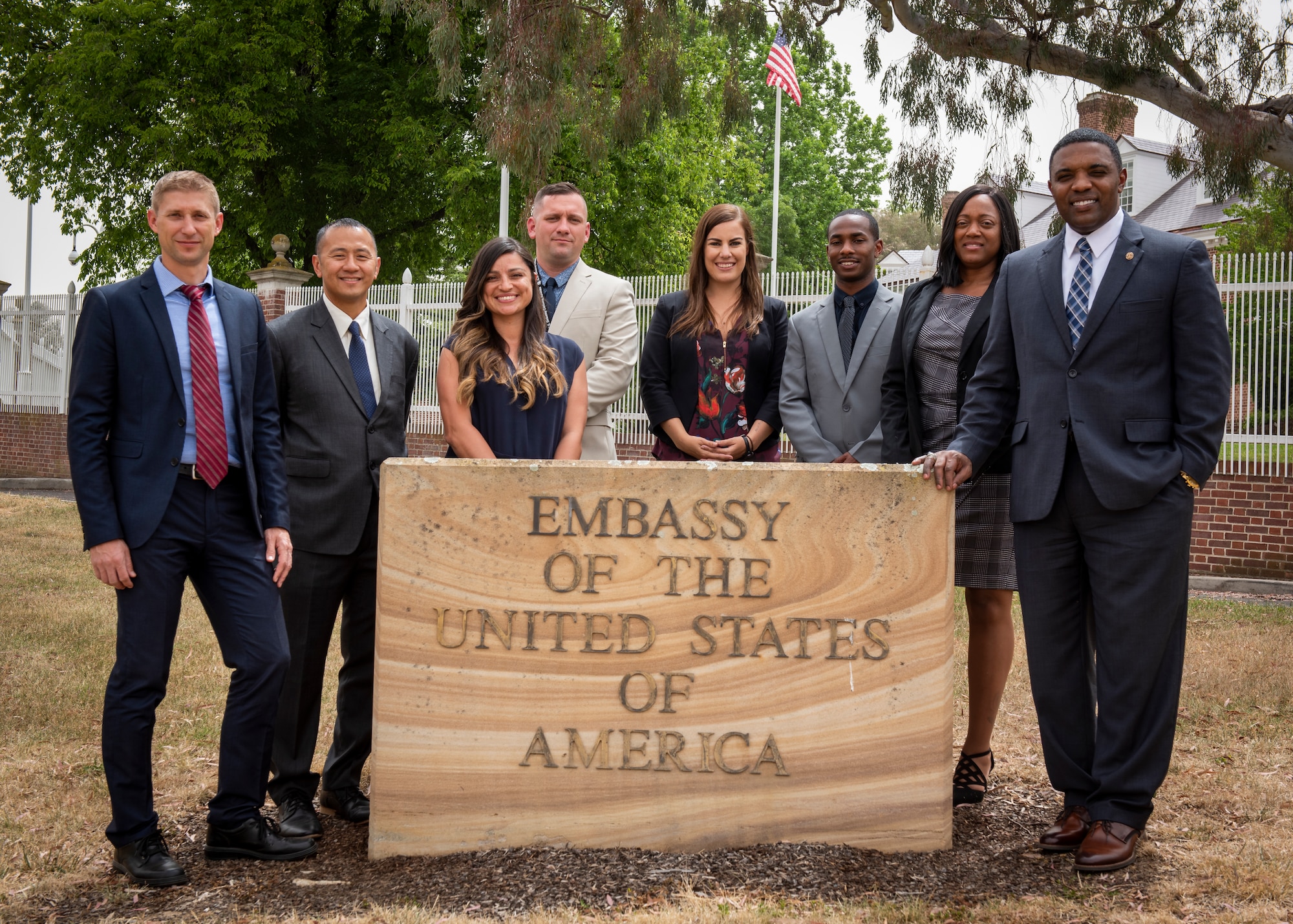 Technical Sgt. Amanda Osborne stands with members from the 337th Air Support Flight behind the Embassy of the United States of America in Canberra, Australia.