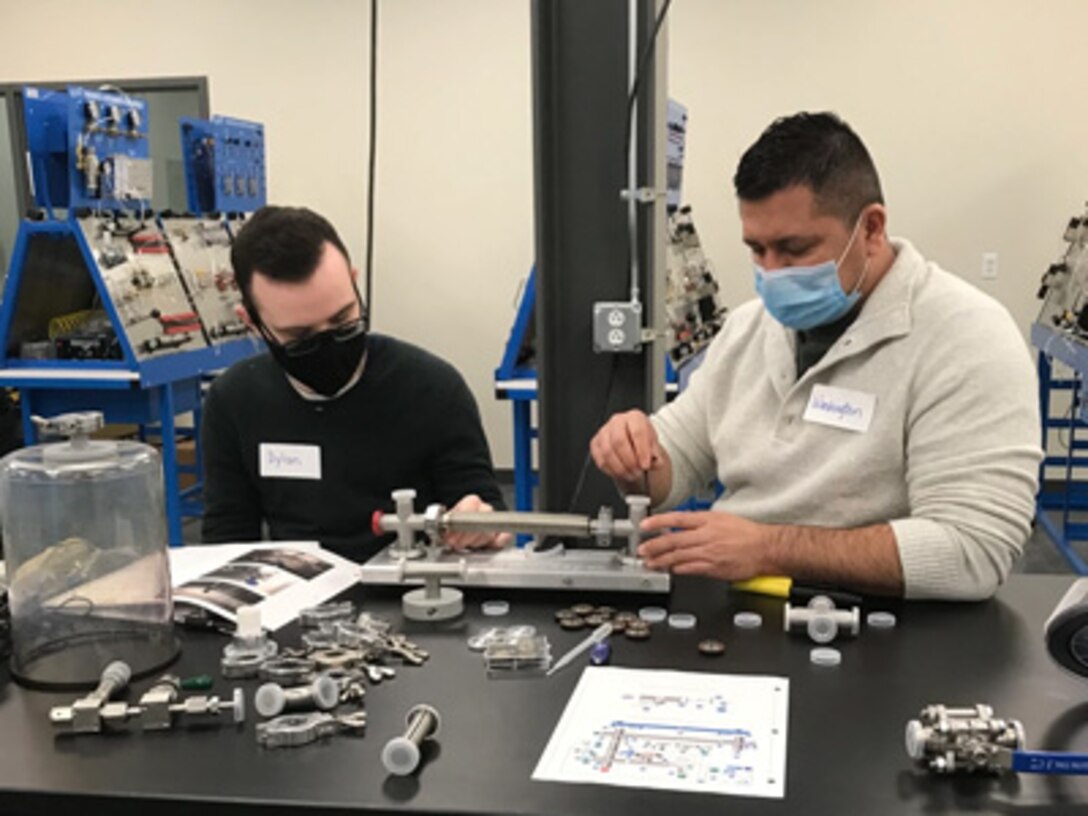 Pfc. Dylan Buckler (left), a recovering Soldier at the Fort Drum Soldier Recovery Unit (SRU) in New York, participates in the STEP (Semiconductor Training &amp; Experience Program) in January 2022.