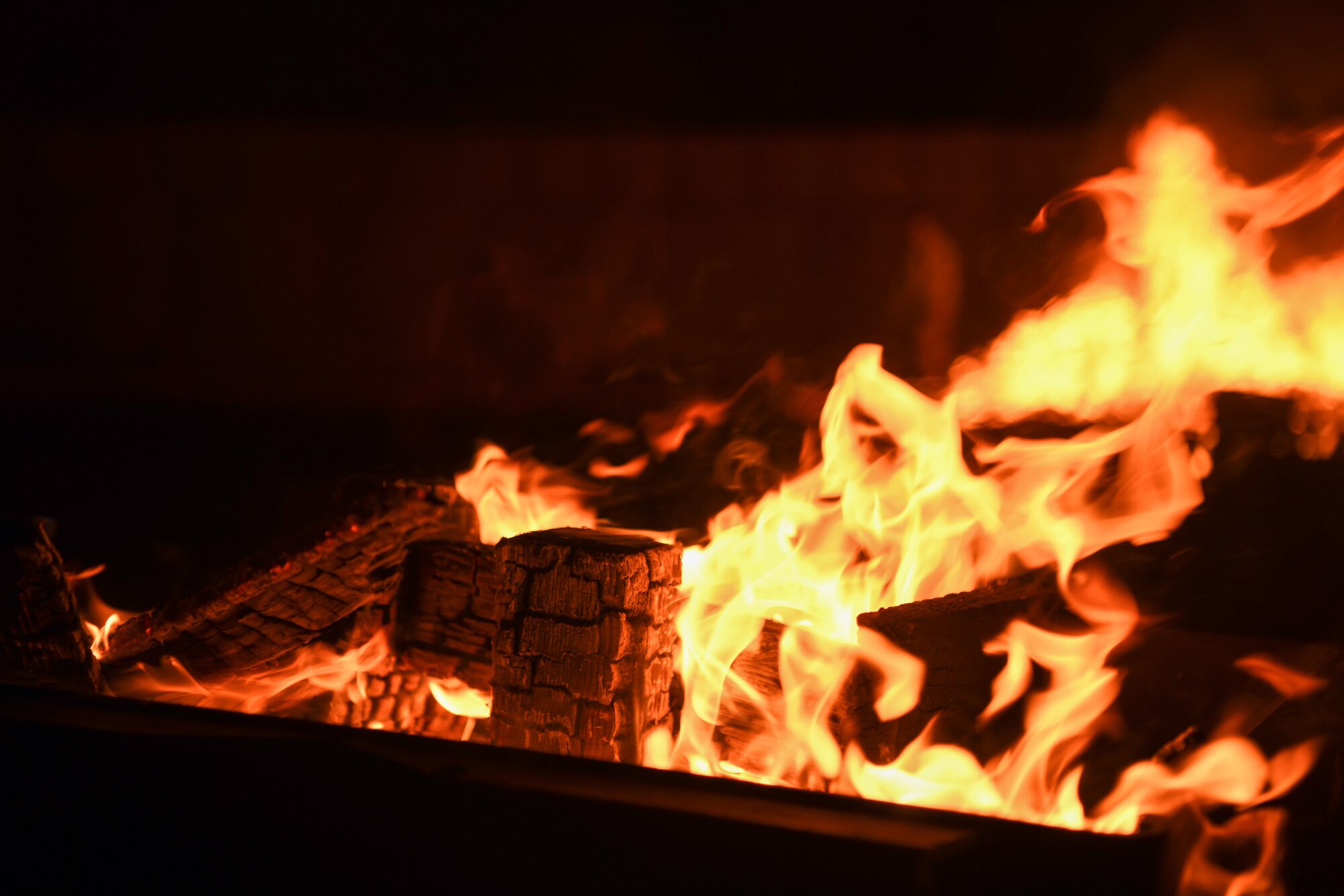 A bonfire burns at Chabelley Airfield, Djibouti, Feb. 5, 2022. The focal piece of a morale event, the bonfire gave joint service members a piece of home through roasting marshmallows and making s’mores. Events like this help members build relationships and enable resiliency. (U.S. Air Force photo by Senior Airman Ericka A. Woolever)