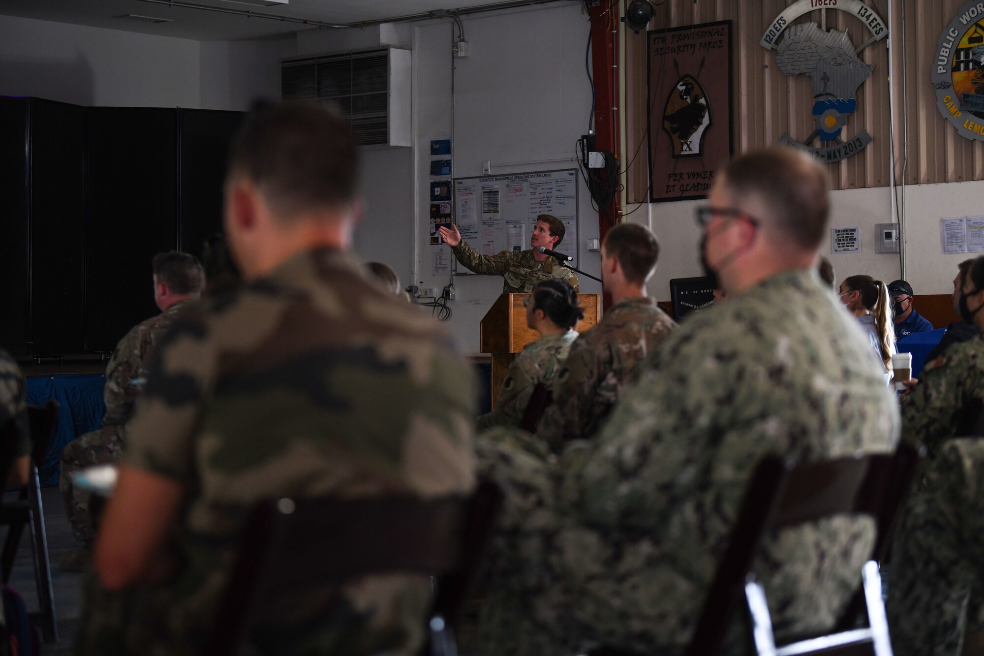 Senior Airman Cameron Ware, 82nd Expeditionary Rescue Squadron pararescuemen, briefs joint service members and allied partners during an international medical conference at Camp Lemonnier, Djibouti, Feb. 3, 2022. The 82nd ERQS are qualified experts in advanced weapons and small unit tactics, airborne and military free fall, combat divers, high angle and confined space rescue operations, small boat and vehicle craft utilization, rescue swimmers, and battlefield trauma-paramedics. (U.S. Air Force photo by Senior Airmen Ericka A. Woolever)
