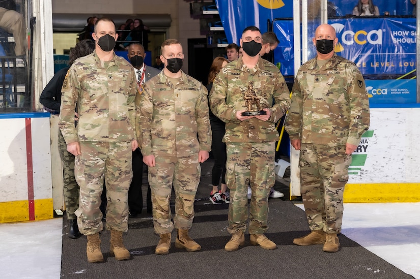 Photo of SFC Frank E. Boehme, Jr. is being presented the Warfighter of the Quarter award