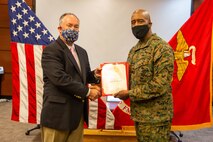 U.S. Marine Corps Lt. Gen. Michael E. Langley, the commanding general of Fleet Marine Force, Atlantic (FMFLANT), Marine Forces Command (MARFORCOM), Marine Forces Northern Command (MARFOR NORTHCOM), awards a certificate of retirement to Joseph W. Murphy, executive director of FMFLANT, MARFORCOM, MARFOR NORTHCOM, during a retirement ceremony at Naval Support Activity Hampton Roads, Norfolk, Virginia, Feb. 24, 2022. FMFLANT, MARFORCOM, MARFOR NORTHCOM is a command active component operating forces and deployment planning and execution of operating forces in support of Combatant Commander and service requirements. (U.S. Marine Corps photo by Sgt. Kealii De Los Santos)