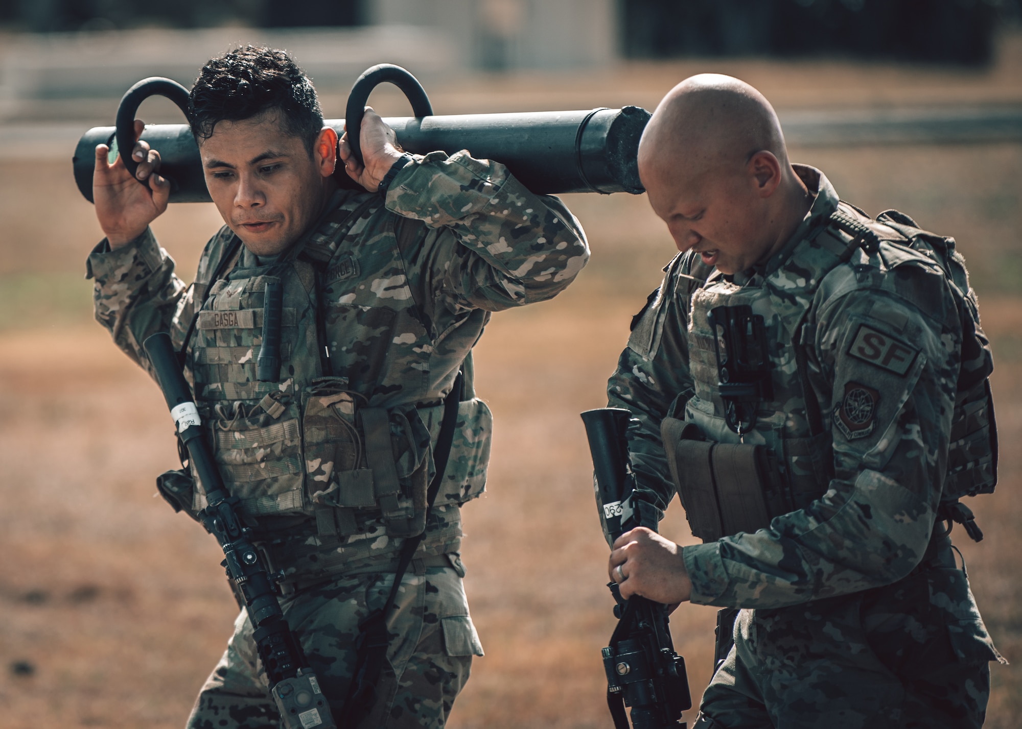 U.S. Air Force Airman 1st Class Yazin Gasga (left) and U.S. Air Force Senior Airman Ethan Vuckovich (right), defenders assigned to the 6th Security Forces Squadron, work together on an assigned objective during emergency services team (EST) tryouts at MacDill Air Force Base, Florida, Feb. 4, 2022.