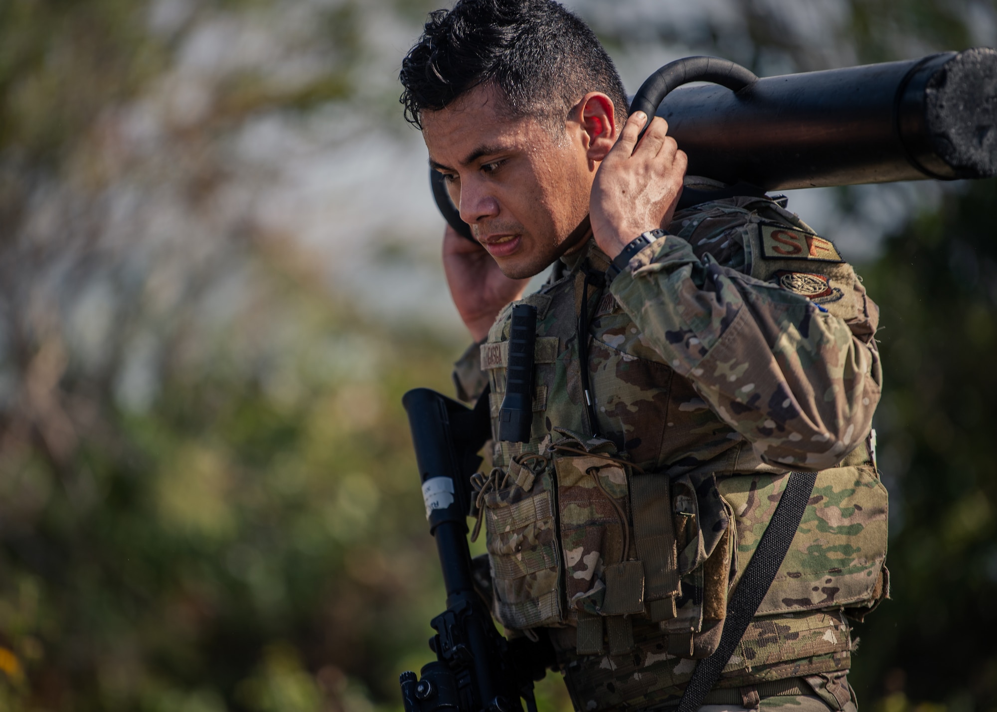 U.S. Air Force Airman 1st Class Yazin Gasga, 6th Security Forces Squadron entry controller, carries a battering ram during Emergency Services Team (EST) tryouts at MacDill Air Force Base, Florida, Feb. 4, 2022.