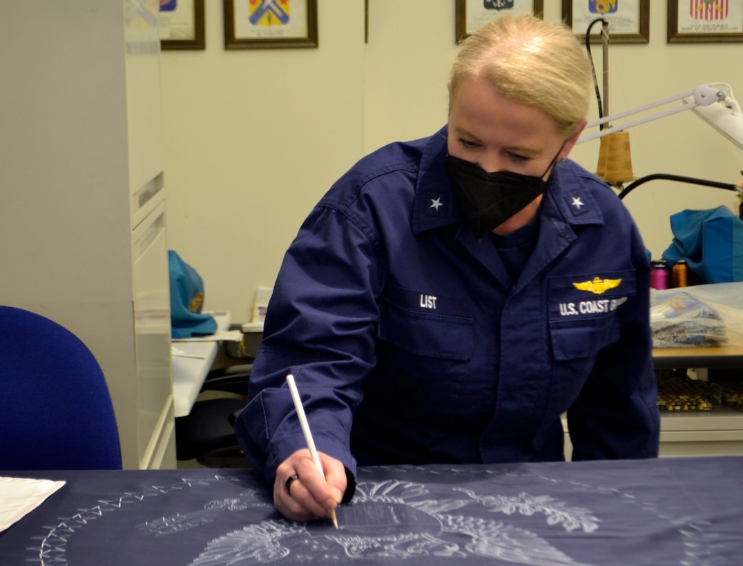 uniformed woman signs flag