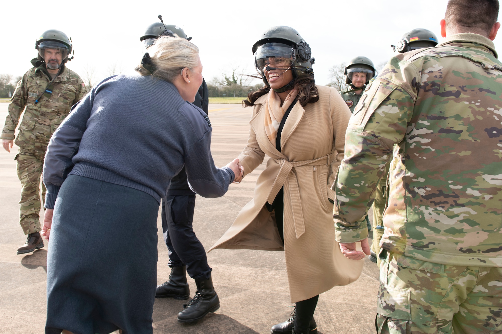Royal Air Force Sq. Ldr. Jayne Robertson, left, RAF commander for RAF Fairford, greets a distinguished visitor at RAF Fairford, England, Feb. 21, 2022. The tour these dignitaries and guests were on was meant to give representatives from allied nations insights into the capabilities and operations of U.S. Air Forces in the United Kingdom. (U.S. Air Force photo by Senior Airman Jennifer Zima)