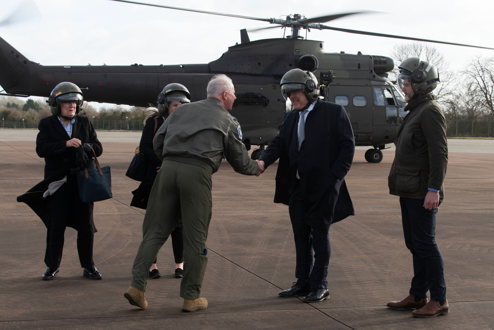 U.S. Air Force Col. Charles Metrolis, center left, U.S. Embassy U.S. Defense Air Attaché, greets Baroness Annabel MacNicoll Goldie DL, U.K. Minister of State at the Ministry of Defence, at RAF Fairford, England, Feb. 21, 2022. The tour these dignitaries and guests were on was meant to give representatives from allied nations insights into the capabilities and operations of U.S. Air Forces in the United Kingdom. (U.S. Air Force photo by Senior Airman Jennifer Zima)
