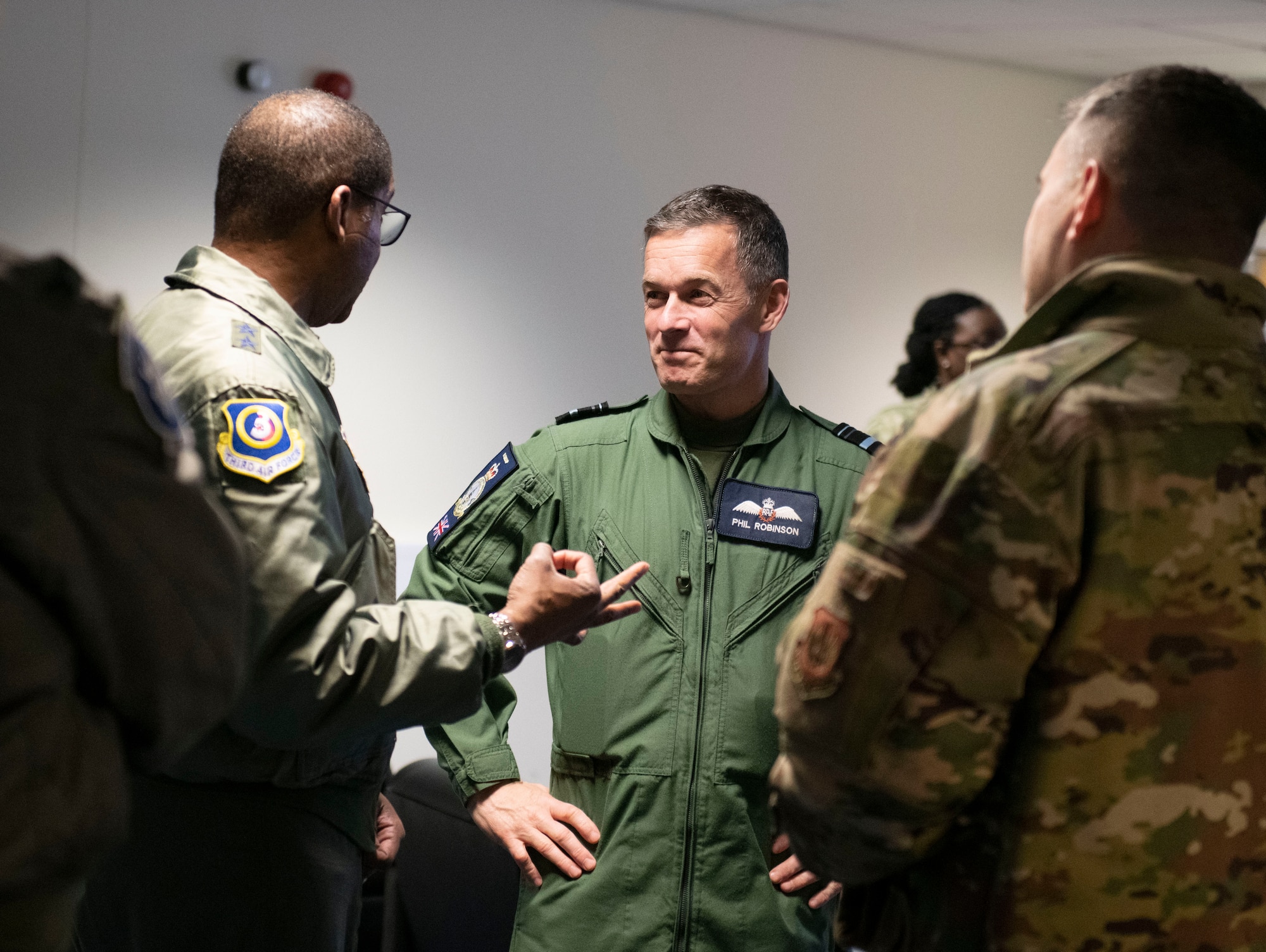 U.S. Air Force Maj. Gen. Randall Reed, Third Air Force commander, left and Air Vice-Marshal Phil Robinson CBE DFC, Air Officer Commanding No. 11 Group, center, at RAF Fairford, England, Feb. 21, 2022. Reed was at Fairford to participate in briefings with representatives from allied nations about the capabilities and operations of U.S. Air Forces in the United Kingdom. (U.S. Air Force photo by Senior Airman Jason W. Cochran)