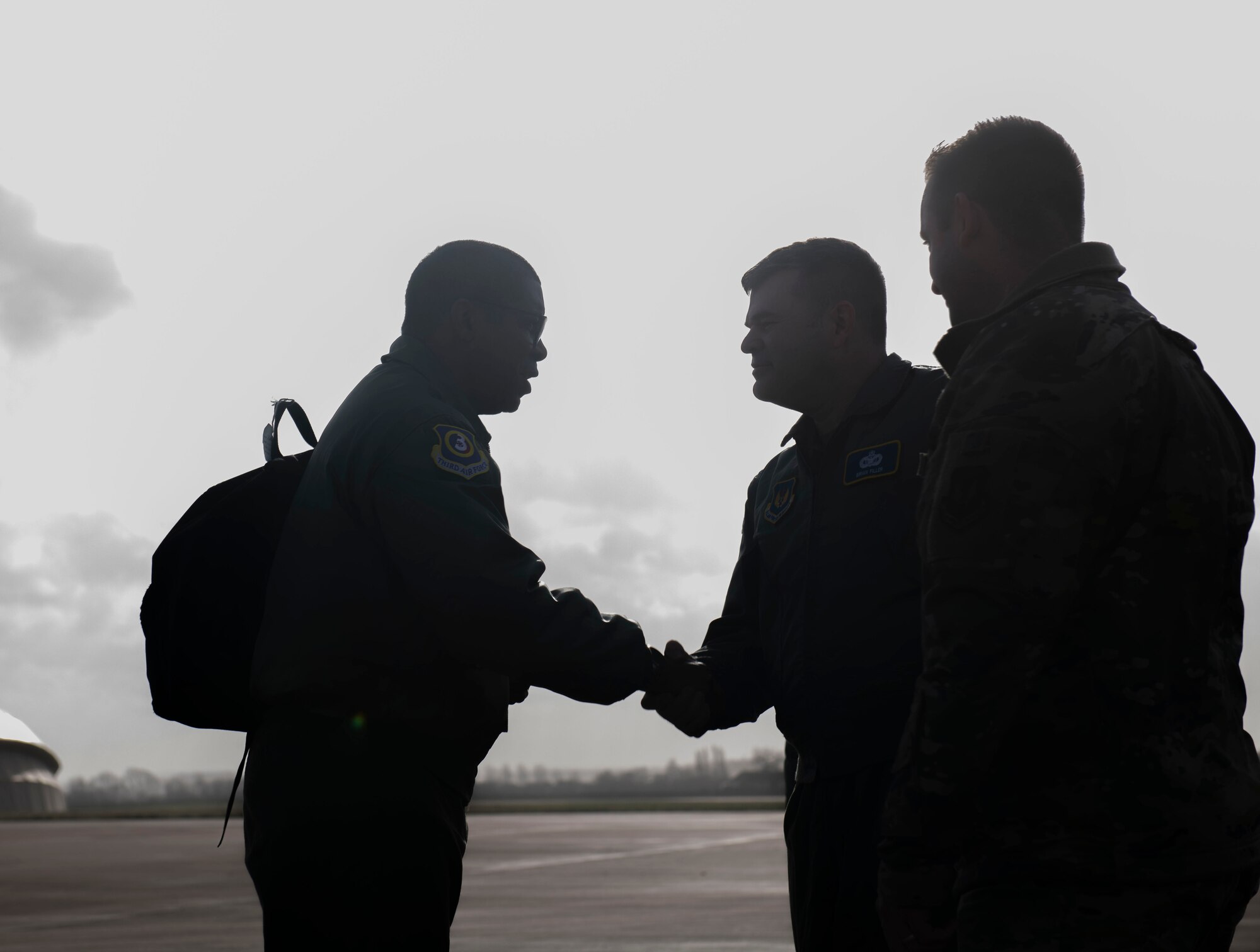 U.S. Air Force Maj. Gen. Randall Reed,Third Air Force commander, left, says goodbye to Col. Brian Filler, 501st Combat Support Wing (CSW) commander, center and Chief Master Sgt. Joshua Trundle, 501st CSW command chief, prior to Reed’s departure from RAF Fairford, England, Feb. 22, 2022. Reed was at Fairford to participate in briefings with representatives from allied nations about the capabilities and operations of U.S. Air Forces in the United Kingdom. (U.S. Air Force photo by Senior Airman Jason W. Cochran)