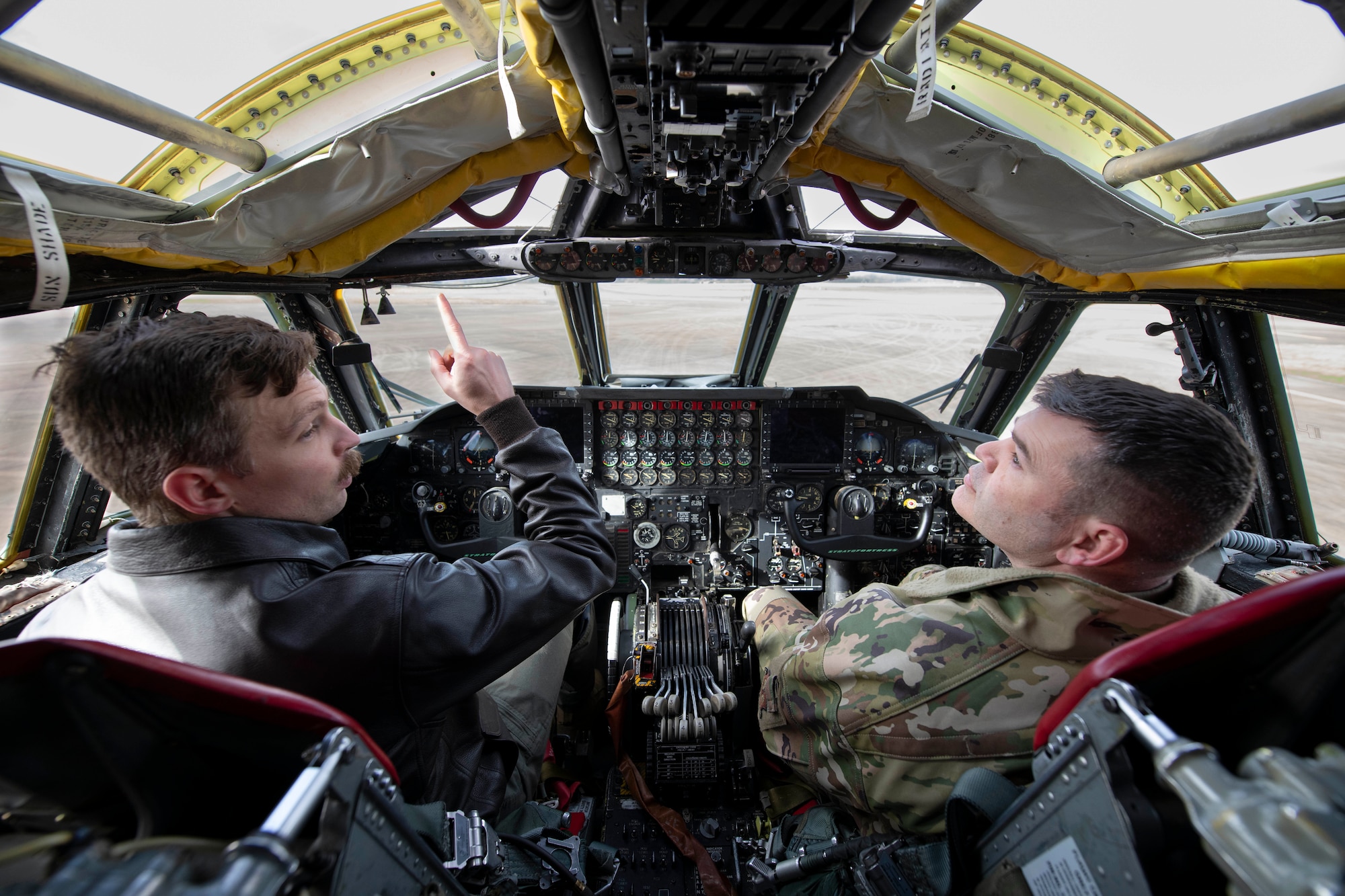 A U.S. Air Force B-52H Stratofortress pilot, left, assigned to the 69th Expeditionary Bomb Squadron, speaks with Col. Brian Filler, right, 501st Combat Support Wing commander, at RAF Fairford, England, Feb. 21, 2022. Filler completed several pre-flight requirements prior to boarding a B-52H Stratofortress for a familiarization flight. (U.S. Air Force photo by Senior Airman Jennifer Zima)