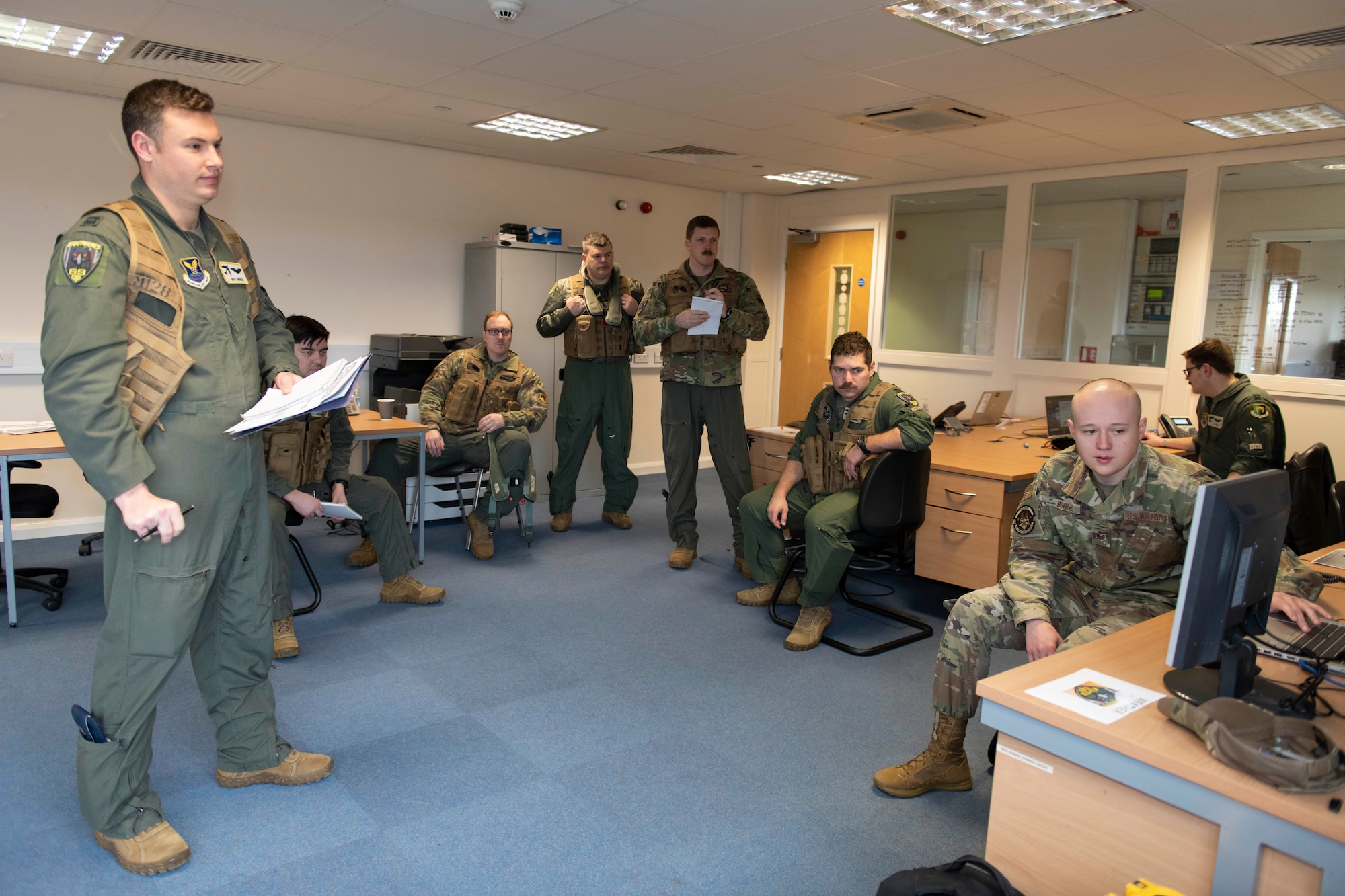 U.S. Air Force Staff Sgt. Joseph Burner, right, 69th Expeditionary Bomb Squadron weather Airman, conducts a pre-flight brief at RAF Fairford, England, Feb. 22, 2022. Col. Brian Filler, center, 501st Combat Support Wing commander, completed several pre-flight requirements prior to boarding a B-52H Stratofortress for a familiarization flight. (U.S. Air Force photo by Senior Airman Jennifer Zima)