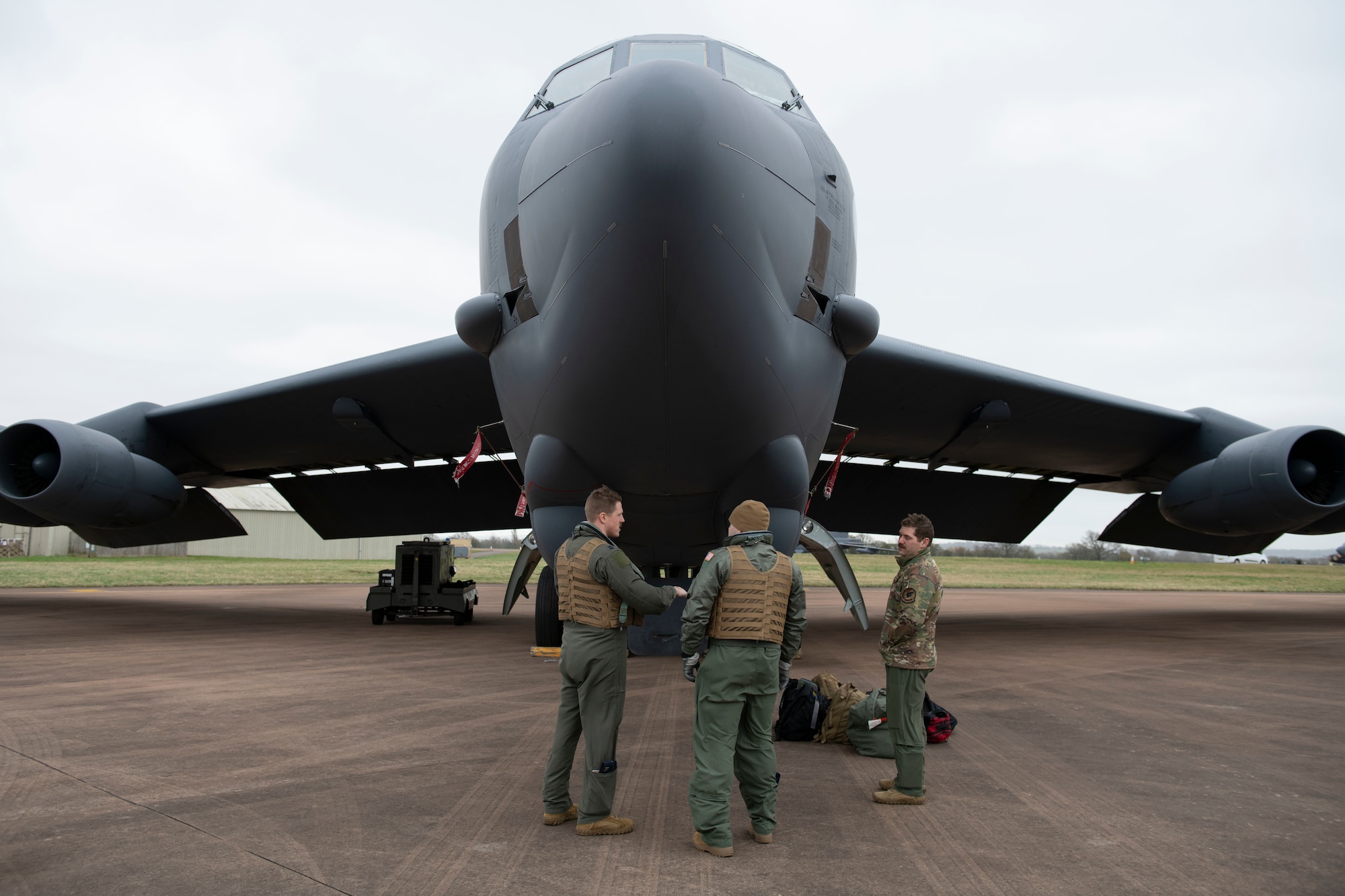 A U.S. Air Force B-52H Stratofortress pilot, left, assigned to the 69th Expeditionary Bomb Squadron, conducts an pre-flight inspection with Col. Brian Filler, center, 501st Combat Support Wing commander, at RAF Fairford, England, Feb. 22, 2022. Filler completed several pre-flight requirements prior to boarding a B-52H Stratofortress for a familiarization flight. (U.S. Air Force photo by Senior Airman Jennifer Zima)
