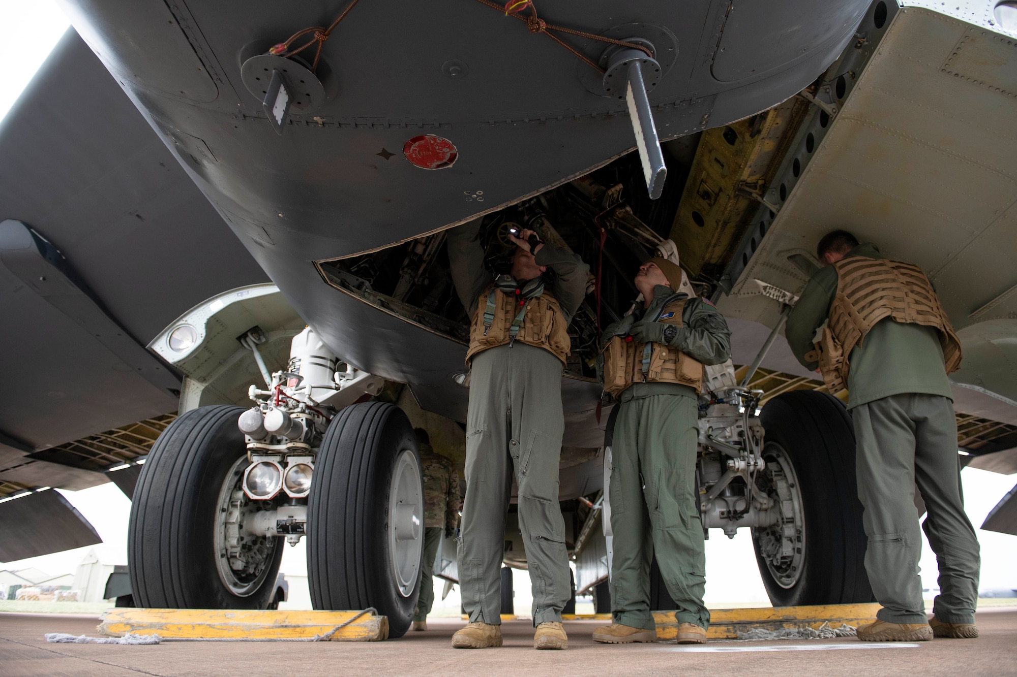 A U.S. Air Force B-52H Stratofortress pilot, left, assigned to the 69th Expeditionary Bomb Squadron, conducts an pre-flight inspection with Col. Brian Filler, center, 501st Combat Support Wing commander, at RAF Fairford, England, Feb. 22, 2022. Filler completed several pre-flight requirements prior to boarding a B-52H Stratofortress for a familiarization flight. (U.S. Air Force photo by Senior Airman Jennifer Zima)