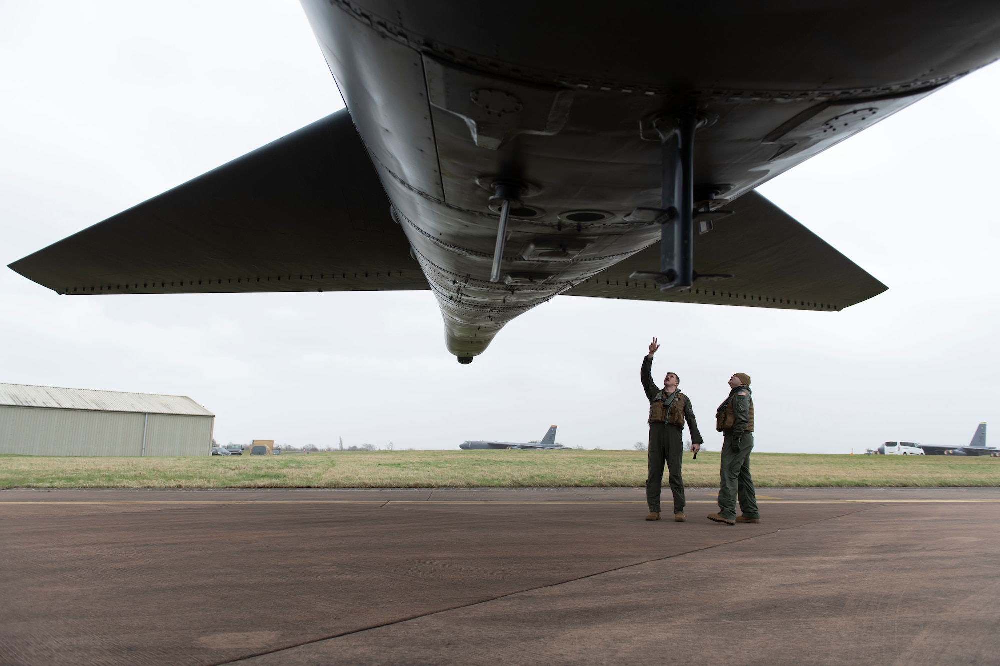 A U.S. Air Force B-52H Stratofortress pilot, left, assigned to the 69th Expeditionary Bomb Squadron, conducts an pre-flight inspection with Col. Brian Filler, center, 501st Combat Support Wing commander, at RAF Fairford, England, Feb. 22, 2022. Filler completed several pre-flight requirements prior to boarding a B-52H Stratofortress for a familiarization flight. (U.S. Air Force photo by Senior Airman Jennifer Zima)