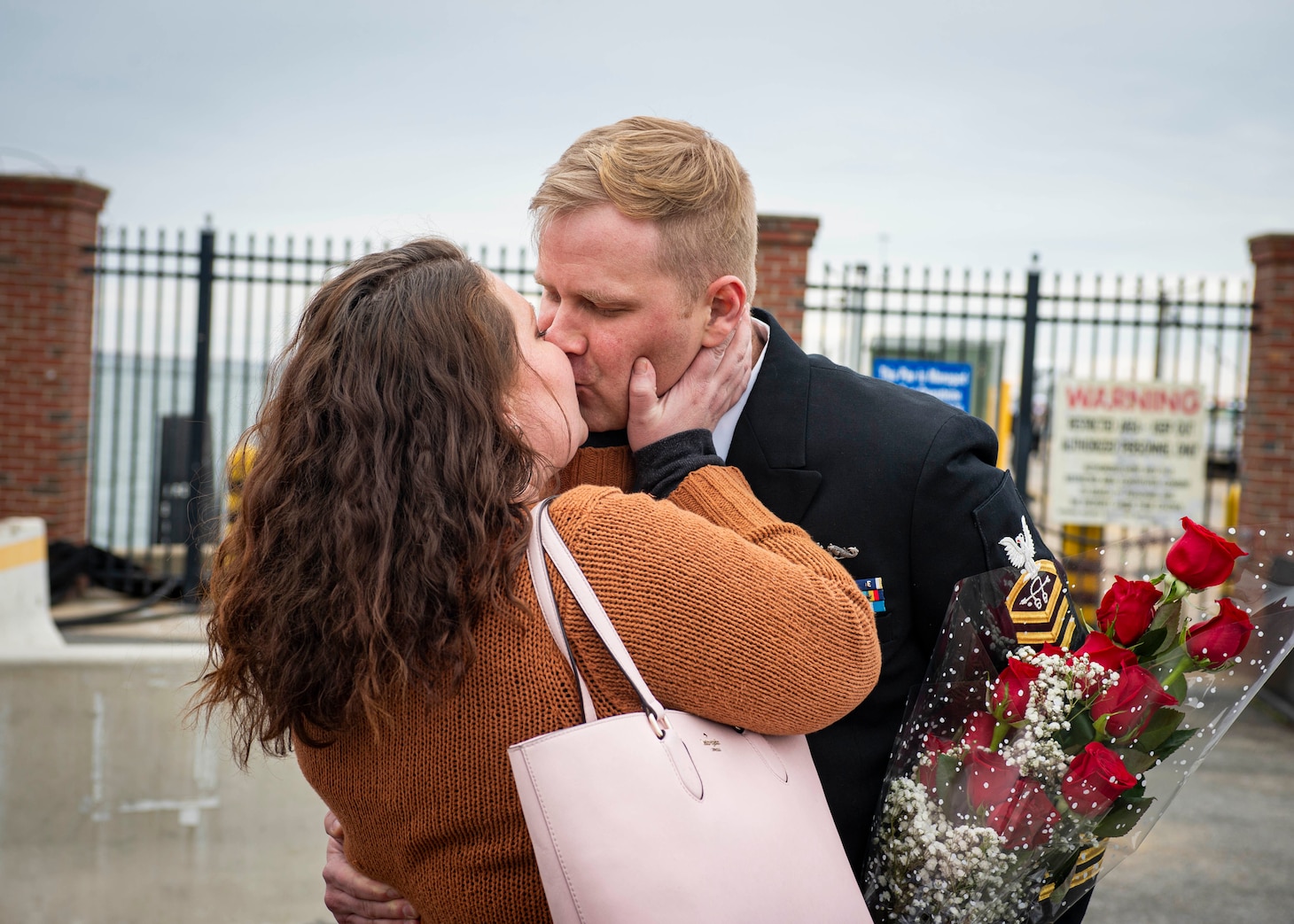Chief Sonar Technician (Submarine) Peter Hamer, assigned to the Virginia-Class fast-attack submarine USS Washington (SSN 787), kisses his significant other during the boat’s homecoming at Naval Station Norfolk, Feb. 27, 2022.