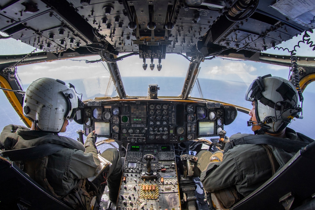 U.S. Marine Corps Capt. Eric Viscardi, right, a division officer originally from Marietta, Georgia, and Capt. Michael Fecteau, an operations officer and a native of North Berwick, Maine, both assigned to Marine Medium Tiltrotor Squadron 165, 11th Marine Expeditionary Unit, pilot a CH-53E Super Stallion during routine flight operations, Feb. 18, 2022. Marines and Sailors of the 11th MEU and Essex Amphibious Ready Group are underway conducting routine operations in U.S. 3rd Fleet.