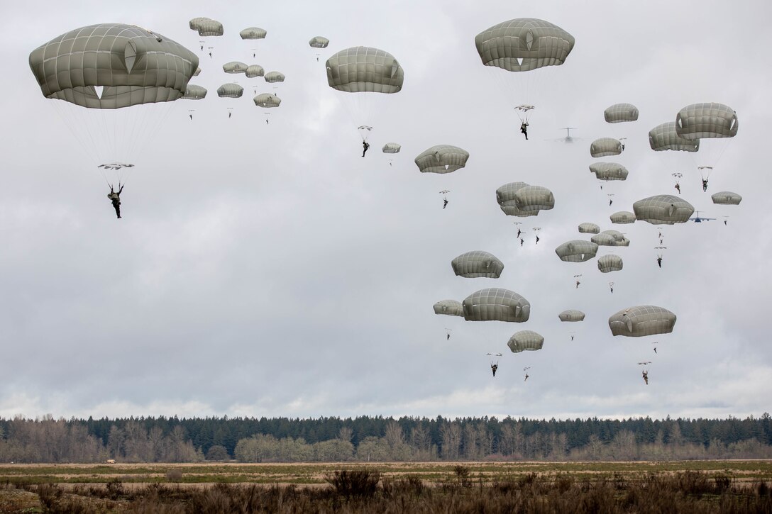 Soldiers parachute to the ground.