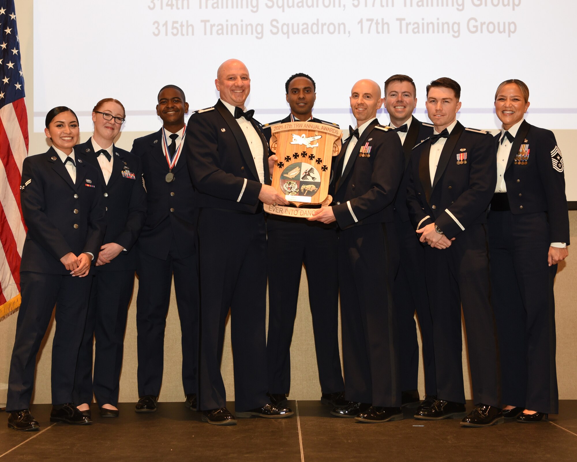 U.S. Air Force Col. Matthew Reilman, 17th Training Wing commander, presents the 17th TRW Agency of the Year award during the 29th Annual Awards Ceremony at the McNease Convention Center, San Angelo, Texas, Feb. 26, 2022. The 17th TRW Legal Office earned the Agency of the Year in 2021. (U.S. Air Force photo by Senior Airman Abbey Rieves)