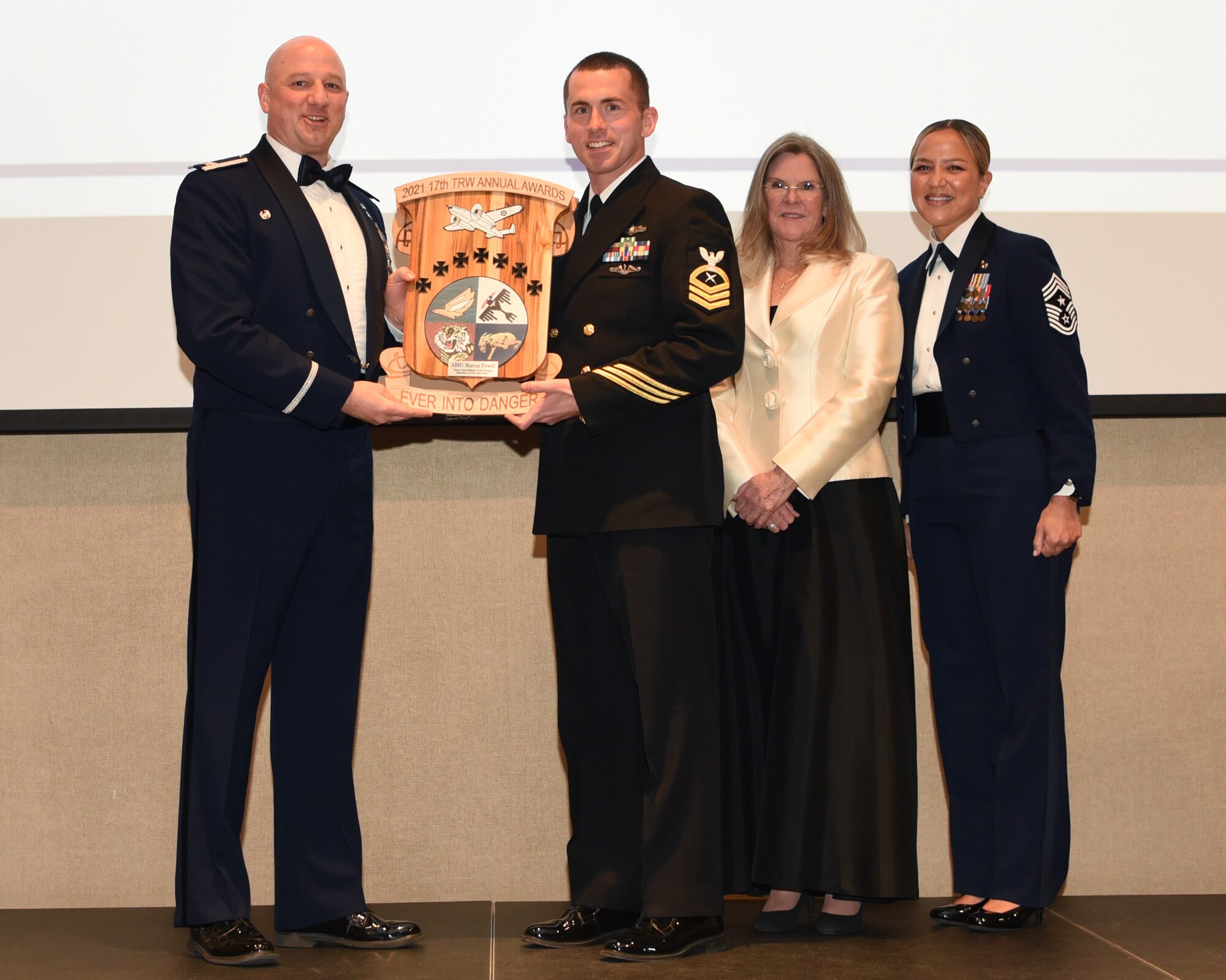 U.S. Air Force Col. Matthew Reilman, 17th Training Wing commander, presents U.S. Navy Chief Petty Officer Anthony Edwards, Navy Center of Information Warfare Detachment, an award during the 29th Annual Awards Ceremony at the McNease Convention Center, San Angelo, Texas, Feb. 26, 2022. Edwards accepted the Team Goodfellow Color Guard Member of the Year award on behalf of Petty Officer 1st Class Marcus Powell Jr, 312th Training Squadron fire protection instructor supervisor. (U.S. Air Force photo by Senior Airman Abbey Rieves)