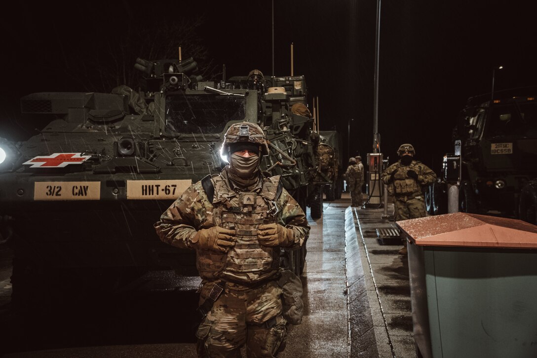 Soldiers refuel their vehicles while on a tactical road march.