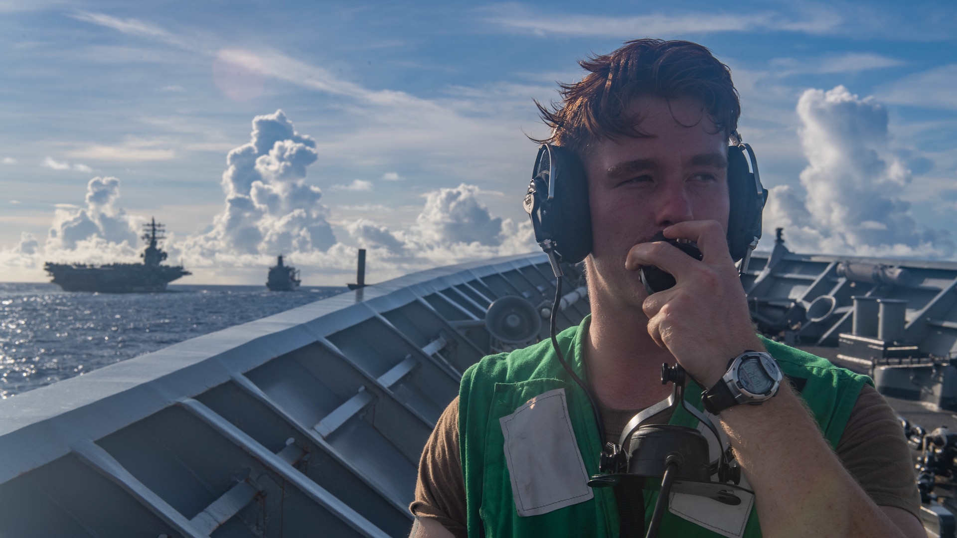 A US Navy Sailor checks comms on July 22, 2020 as the phone and distancing line signalman on the forecastle aboard the Ticonderoga-class guided-missile cruiser USS Antietam (CG 54) before a dual underway replenishment. (U.S. Navy photo by PO3 James Hong)