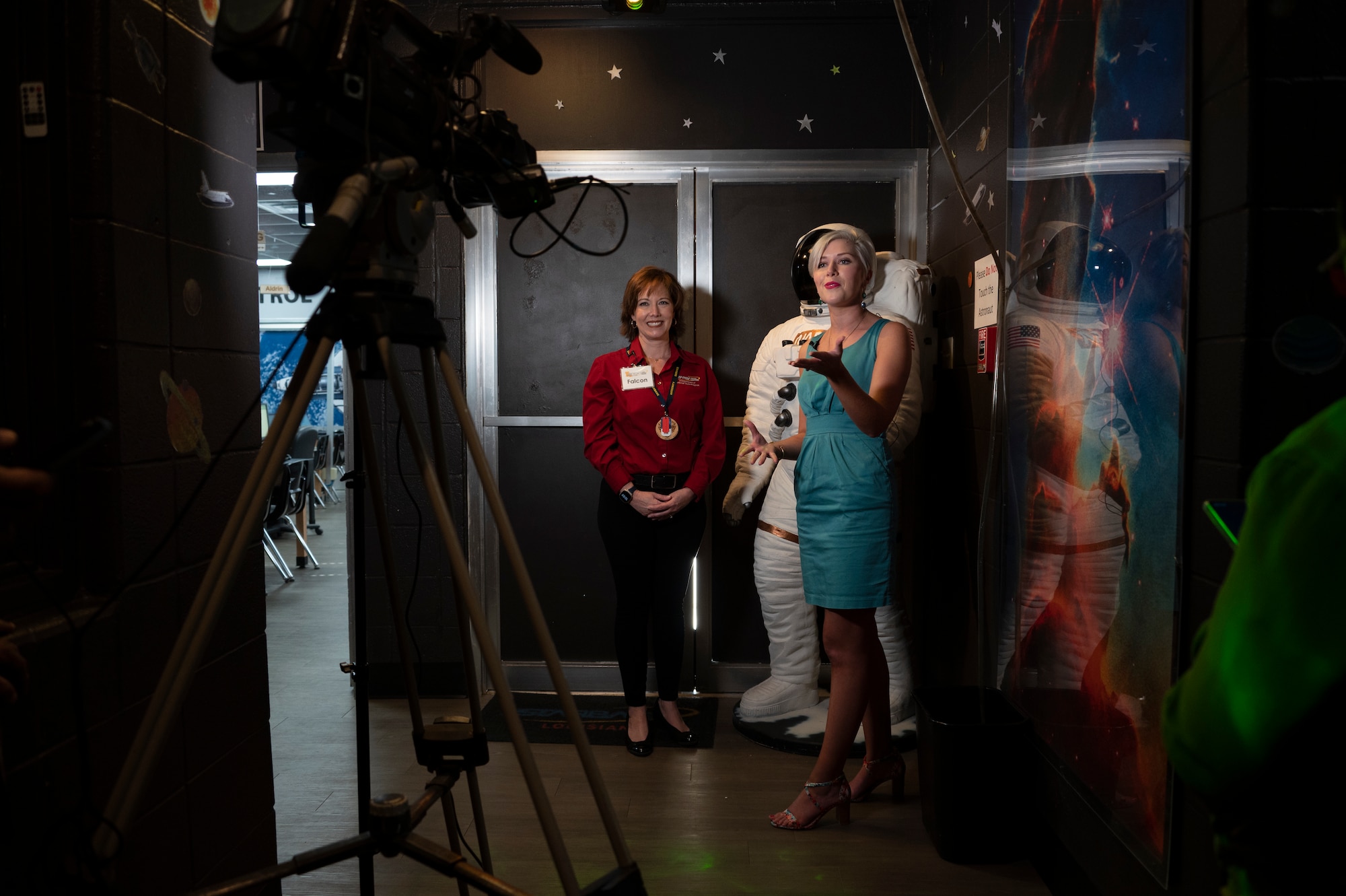 Two females speak in front of a video camera.