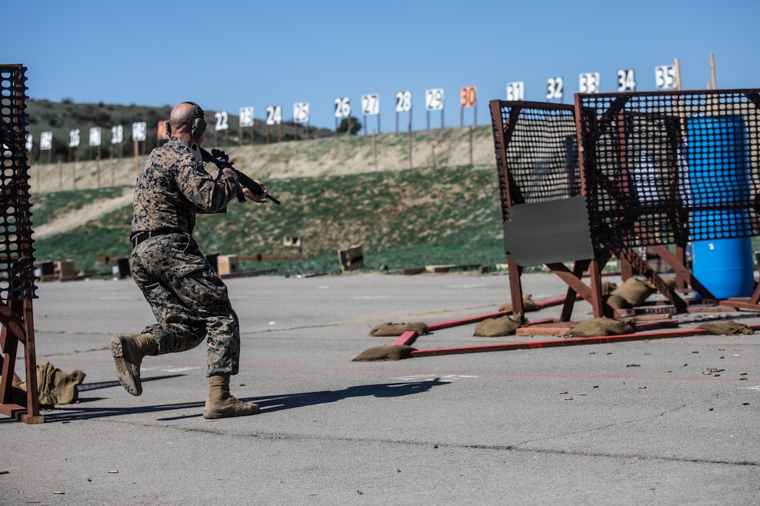 U.S. Marine Corps Sgt. a special reactions team member with Provost Marshals Office, Marine Corps Recruit Depot San Diego, fires his weapon during a competition stage while participating in Marine Corps Marksmanship Competition West (MCMC-W) at Camp Pendleton, Calif., Feb. 17, 2022. In addition to receiving advanced marksmanship training within the action shooting rifle and pistol disciplines, Marines attending the regional MCMCs will also complete their annual rifle and pistol qualifications. (U.S. Marine Corps photo by Cpl. Anthony D. Pio)