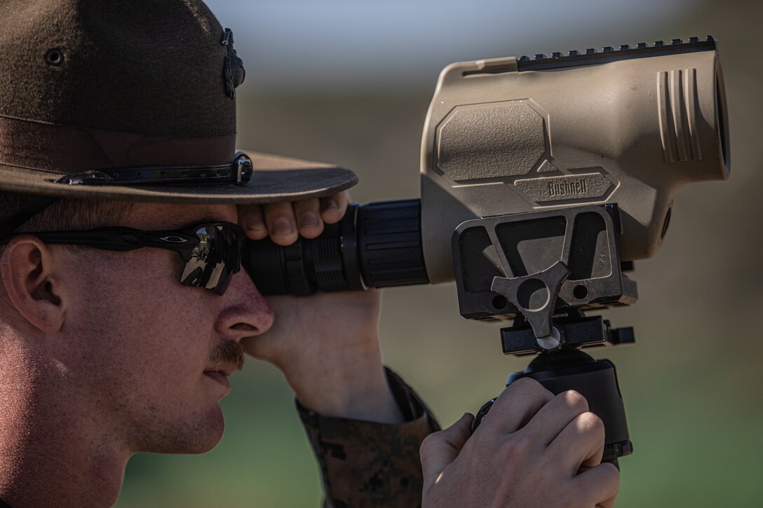 U.S. Marine Corps Sgt. a member of the Marine Corps Shooting Team, spots targets during Marine Corps Marksmanship Competition West (MCMC-W) at Camp Pendleton, Calif., Feb. 17, 2022. MCMC-W provides an opportunity to refine the fundamental skills that make a Marine lethal on the battlefield and able to deliver lethal force in a dynamic environment. (U.S. Marine Corps photo by Cpl. Anthony D. Pio)