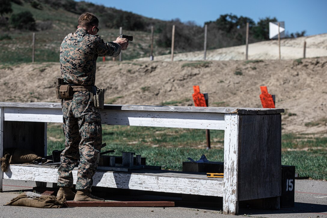 U.S. Marine Corps Sgt. a combat marksmanship trainer instructor with Formal Marksmanship Training Center, Weapons and Field Training Battalion, competes in the pistol team match during Marine Corps Marksmanship Competition West (MCMC-W) at Camp Pendleton, Calif., Feb. 18, 2022. Authorized weapons for MCMC-W are the issued service rifle and service pistol as authorized for annual rifle and pistol training. (U.S. Marine Corps photo by Cpl. Anthony D. Pio)