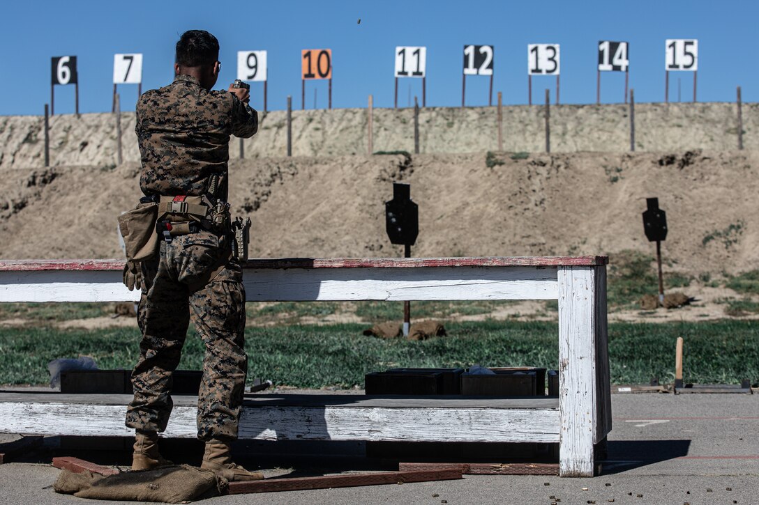 U.S. Marine Corps Sgt. a combat graphics specialist with 12th Marine Corps District, Western Recruiting Region, competes in the pistol team match during Marine Corps Marksmanship Competition West (MCMC-W) at Camp Pendleton, Calif., Feb. 18, 2022. MCMC-W provides an opportunity to refine the fundamental skills that make a Marine lethal on the battlefield and able to deliver lethal force in a dynamic environment. (U.S. Marine Corps photo by Cpl. Anthony D. Pio)