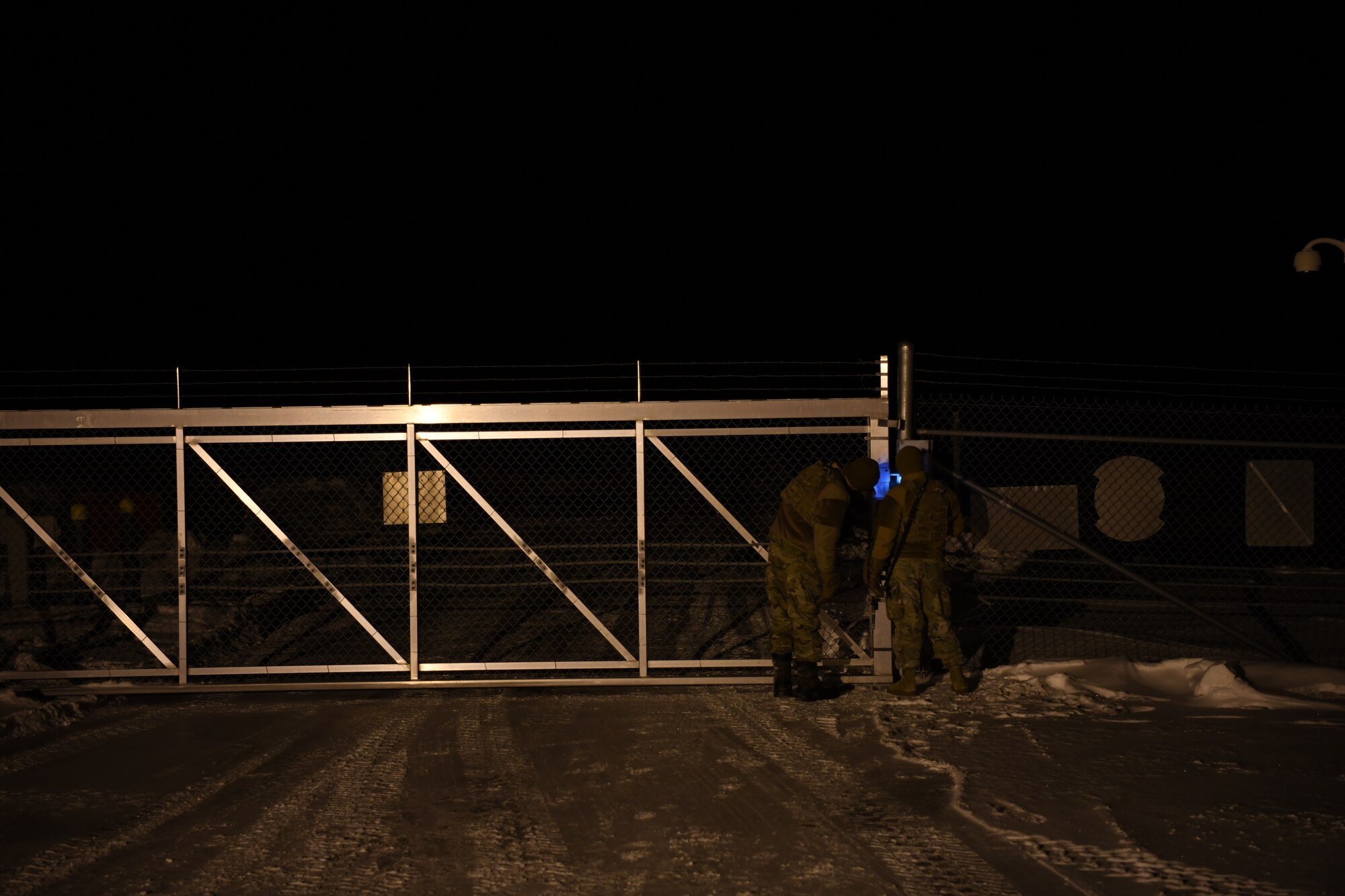 Airmen unlock a gate