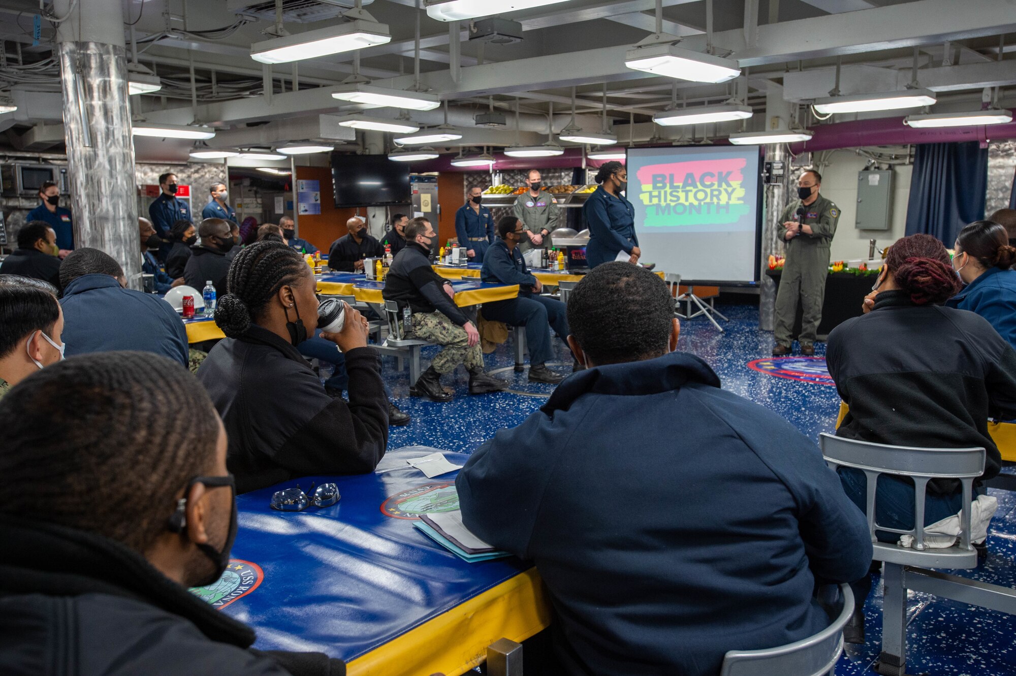 Capt. Fred Goldhammer, commanding officer of the U.S. Navy’s only forward-deployed aircraft carrier USS Ronald Reagan (CVN 76), delivers remarks during a Black History Month celebration on the mess decks, Feb. 24, 2022.