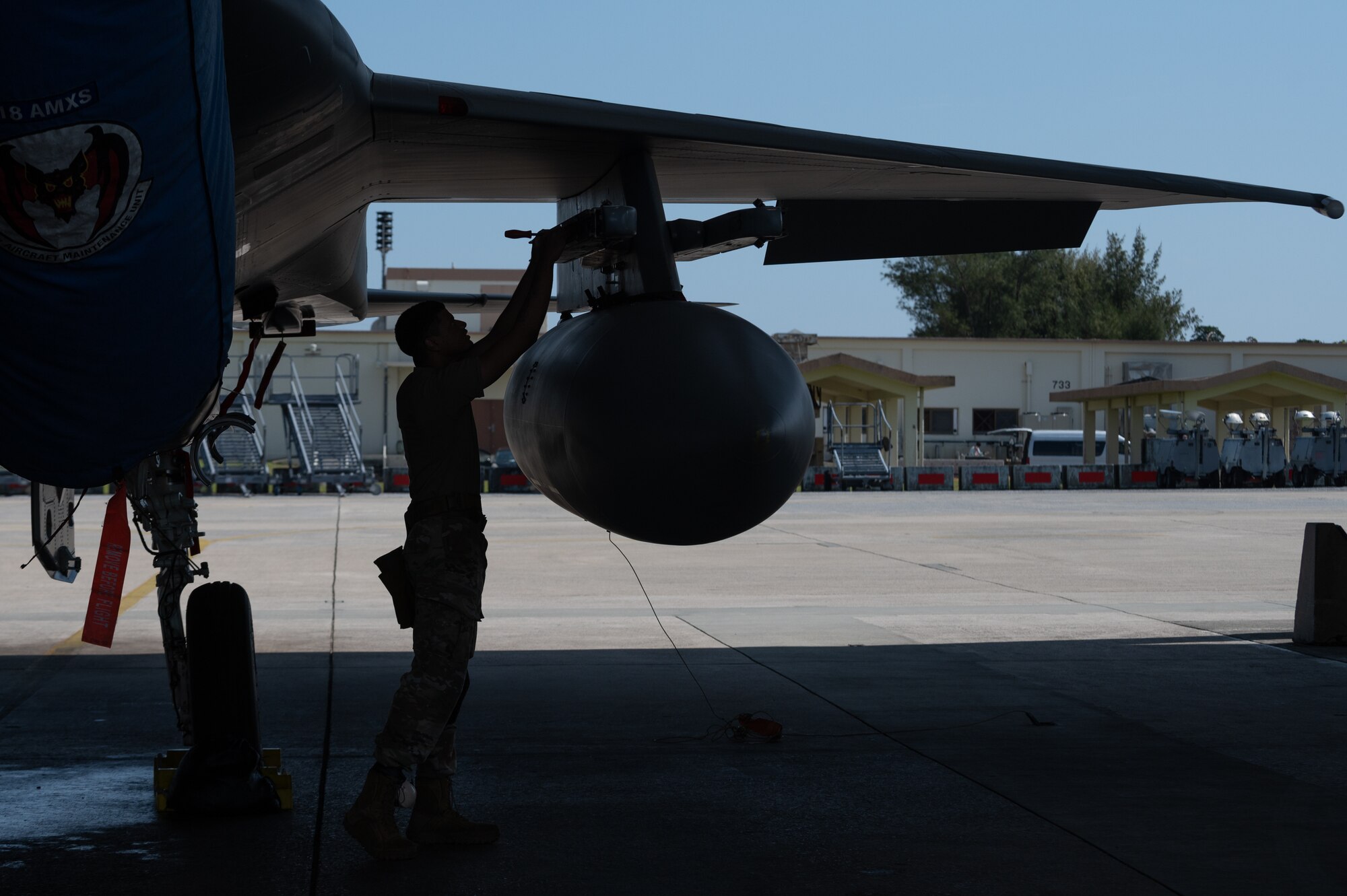 Airman performs maintenance on F-15