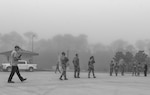 Members of the 1st Special Operations Wing, TK&K Services and Defense Logistics Agency Energy evacuate the hazardous zone of a fuel spill during a spill prevention and response exercise Feb. 24, 2022, at Hurlburt Field, Florida.