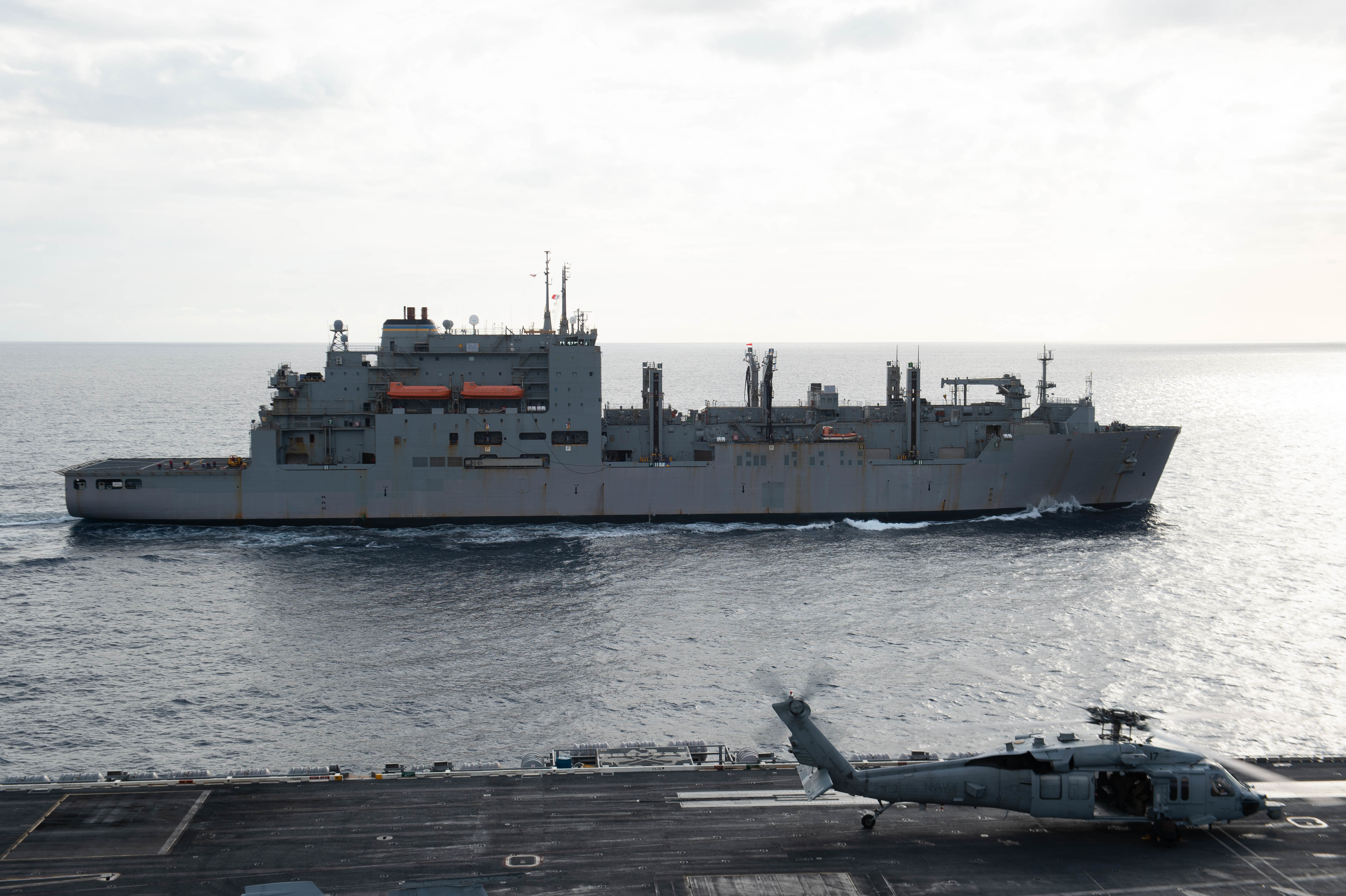The fast combat support ship USNS Supply (T-AOE 6) transits alongside the Nimitz-class aircraft carrier USS Harry S. Truman (CVN 75) during a replenishment-at-sea, Feb. 26, 2022.