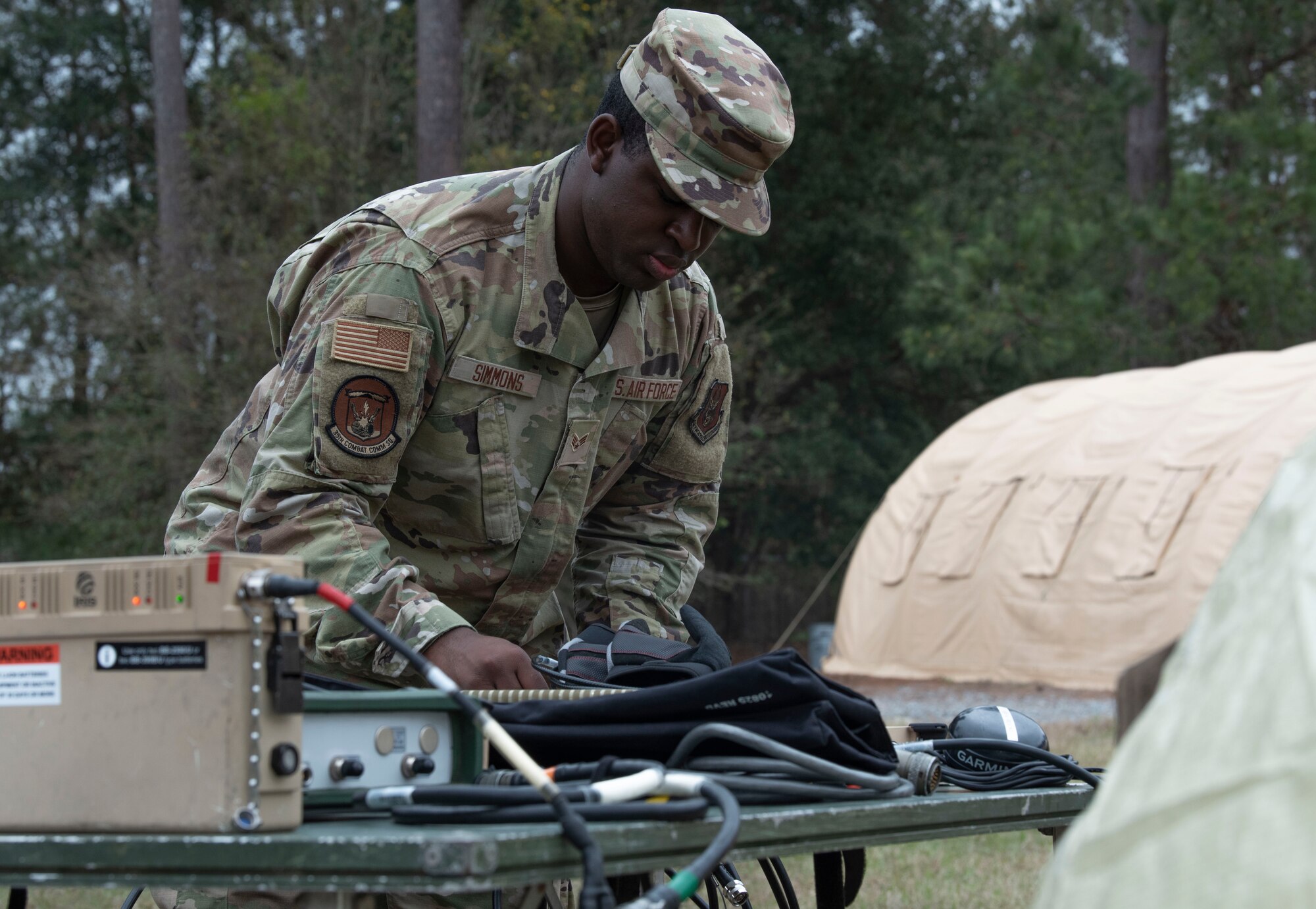 An Airman sets up a communications modem