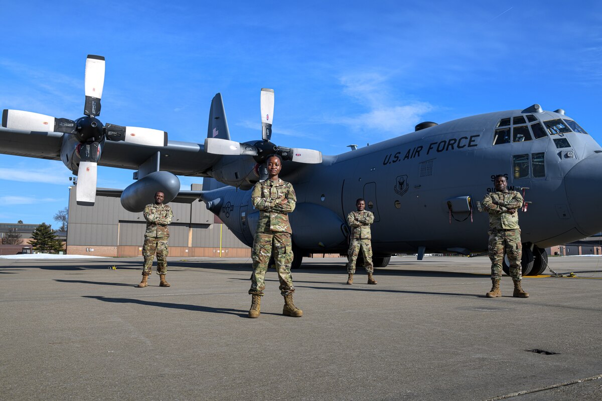 Airmen assigned to the 910th Logistics Readiness Squadron pose for a photo, Jan. 10, 2021, on the flightline at Youngstown Air Reserve Station, Ohio. All four Airmen immigrated to the United States from Kenya or Ghana.