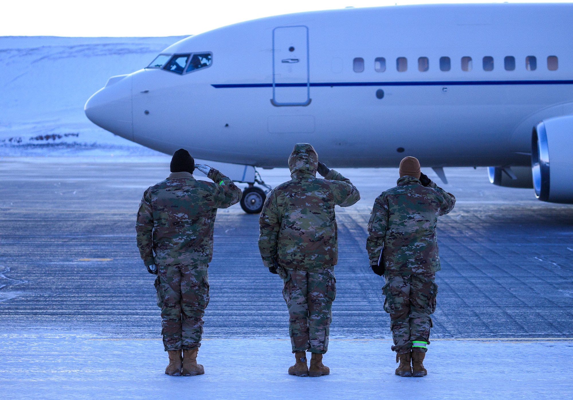 To honor the arrival of the Secretary of the Air Force’s first visit to Thule Air Base, Greenland, the 821st Air Base Group leadership render salutes as the aircraft comes to position at the passenger terminal, Feb. 11, 2022.