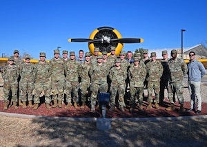 U.S. Air Force Col. James Finlayson, 17th Training Wing vice commander, poses with cadets and cadre from Texas A&M University in front of the T-6 Texan at Goodfellow Air Force Base, Texas Feb. 18, 2022. Cadets were given a tour of Goodfellow and introduced to a few Air Force career fields. (U.S. Air Force photo by Senior Airman Ethan Sherwood)