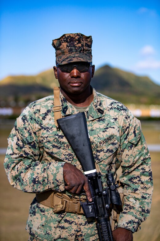 U.S. Marine Corps Master Sgt. Marc Chaplin, a base range noncommissioned officer in charge  with  Headquarters and Support Battalion, Marine Corps Installations Pacific, poses for a portrait during the Marine Corps Marksmanship Competition Far East on Camp Hansen, Okinawa, Japan, Dec. 9, 2021. During the competition, Marines practiced marksmanship on multiple courses of fire while conducting advanced pistol and rifle movement drills to accumulate scored points as a team and as individuals. The Marines with a score in the top 10 percentile will receive a medal and advance to other competitions. The competition is held annually to improve Marines’ marksmanship fundamentals, combat readiness, and proficiency with both rifle and pistol. (U.S. Marine Corps photo by Lance Cpl. Jonathan Beauchamp)