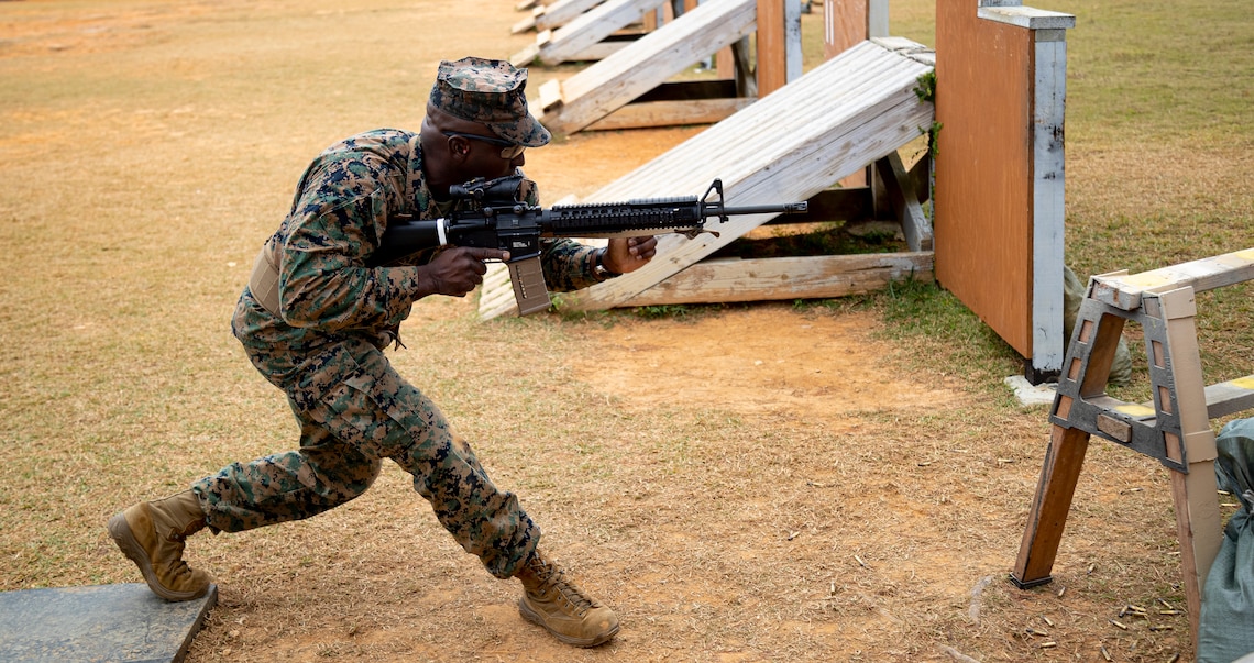U.S. Marine Corps Master Sgt. Marc Chaplin, a base range noncommissioned officer in charge  with  Headquarters and Support Battalion, Marine Corps Installations Pacific, combat glides while conducting a series of drills in preparation for the Marine Corps Marksmanship Competition Far East on Camp Hansen, Okinawa, Japan, Dec. 9, 2021. During the competition, Marines practiced marksmanship on multiple courses of fire while conducting advanced pistol and rifle movement drills to accumulate scored points as a team and as individuals. The Marines with a score in the top 10 percentile will receive a medal and advance to other competitions. The competition is held annually to improve Marines’ marksmanship fundamentals, combat readiness, and proficiency with both rifle and pistol. (U.S. Marine Corps photo by Lance Cpl. Jonathan Beauchamp)