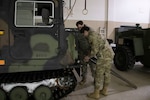 Alaska Air and Army National Guard Airman 1st Class John Villa and Spc. Matthew Ogawa prepare the arctic all-terrain small unit support vehicle to support of the Alaska State Emergency Operations Center. Villa and Ogawa and several other Alaska National Guard members volunteered to support their community, Fairbanks North Star Borough, with emergency transportation needs during a winter storm resulting in extreme snow and ice conditions.