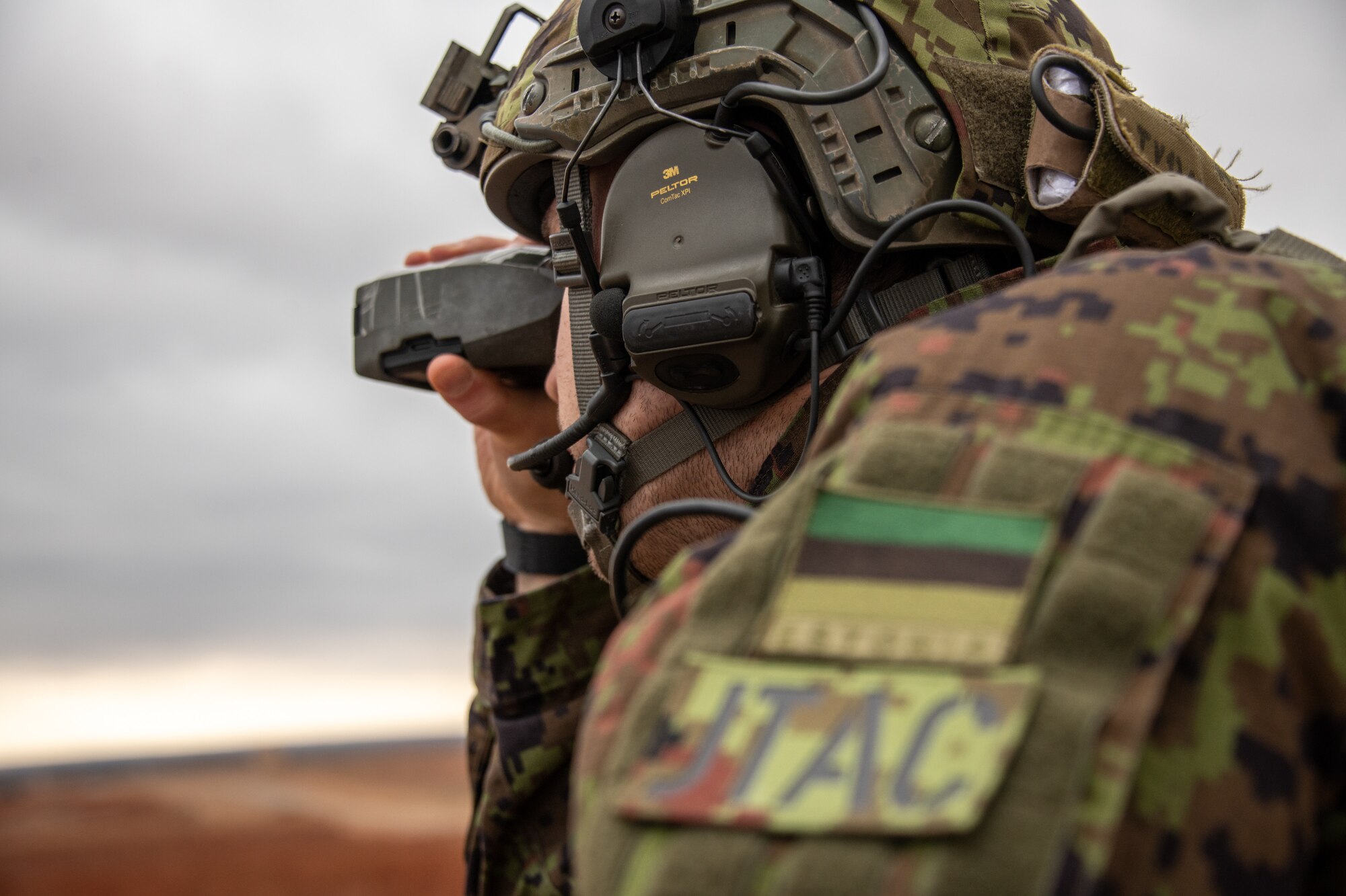 A man peers through a range finder