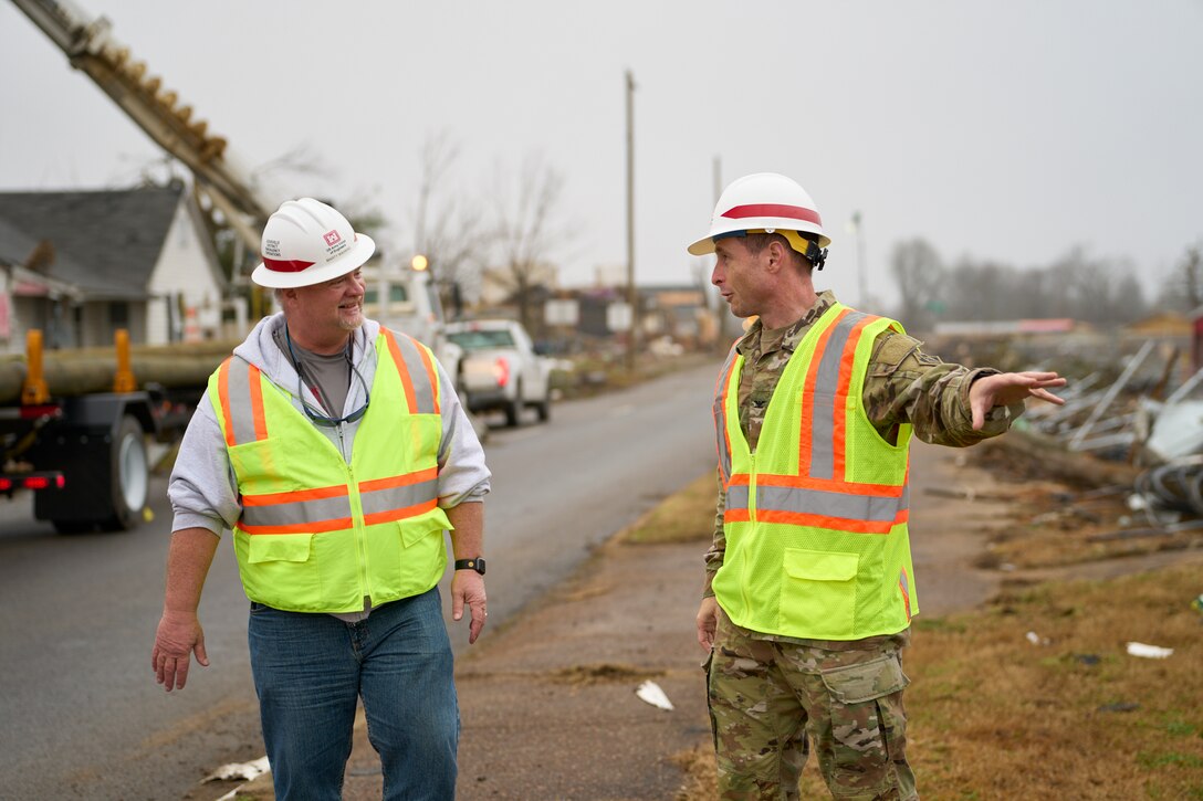 U.S. Army Corps of Engineers Louisville District Commander Col. Eric Crispino discusses debris removal with Marty Wahking Dec. 30, 2021 in Mayfield, Kentucky. USACE began removing debris in the city of Mayfield Dec. 23 after receiving a mission assignment from FEMA to provide debris removal and cleanup in Graves County. (U.S. Army Corps of Engineers photo by Charles Delano)